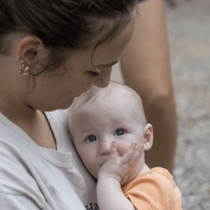 Teenager volunteer holding an infant