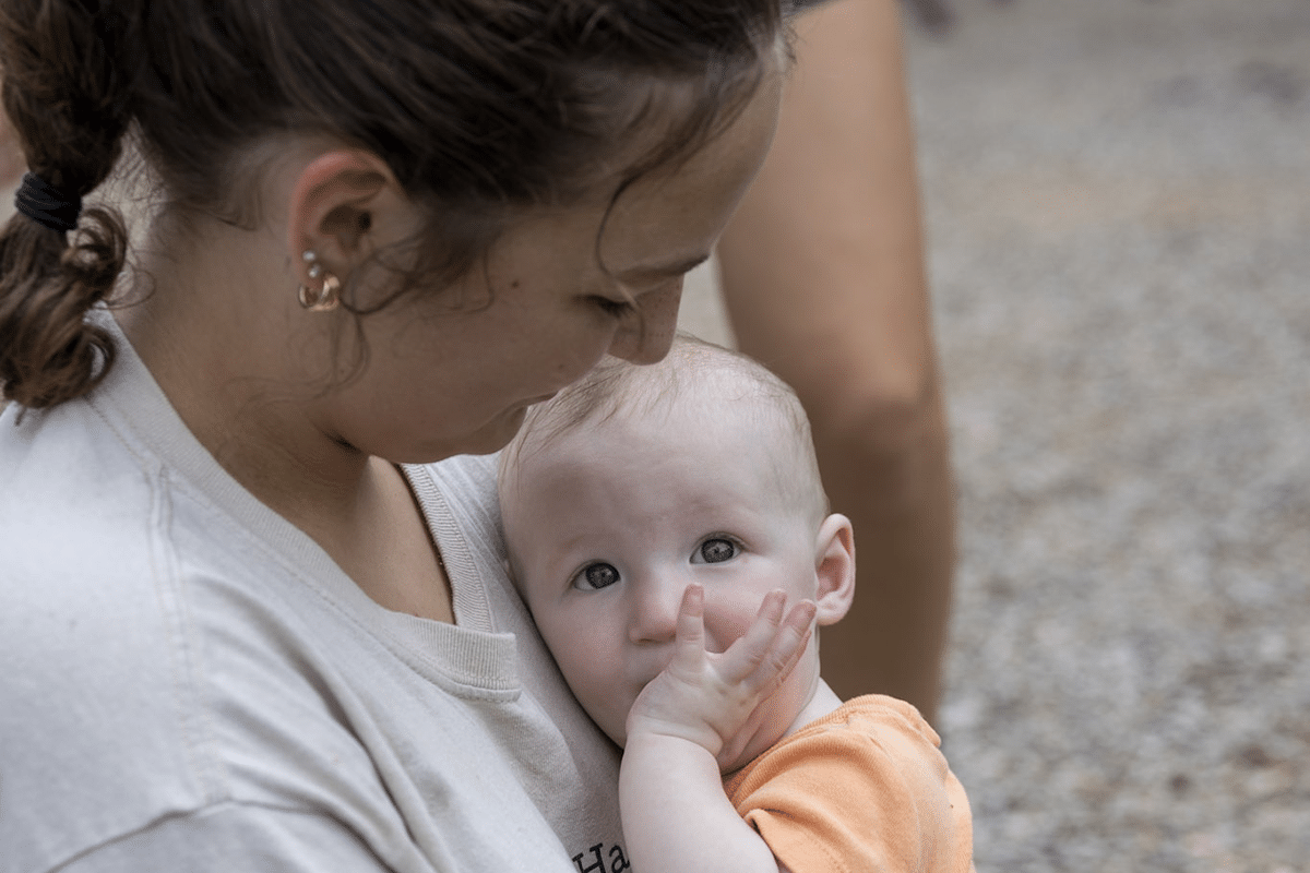 Teenager volunteer holding an infant