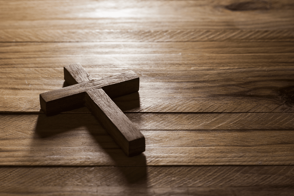 a small wooden cross on a wooden table