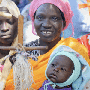 A mother holds her baby during a church service in the Nuba Mountains.